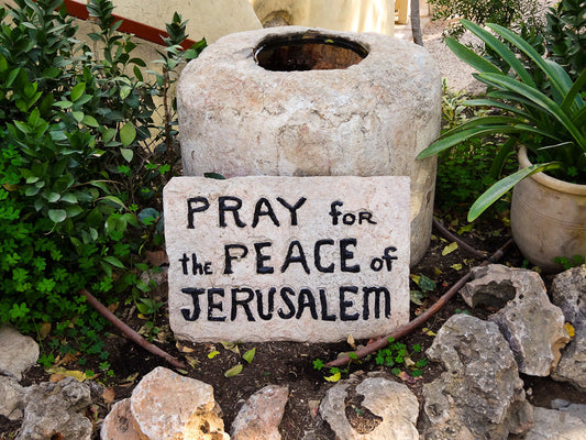 Peaceful view of the Garden Tomb Jerusalem surrounded by trees and stone pathways for Christian pilgrimage and prayer