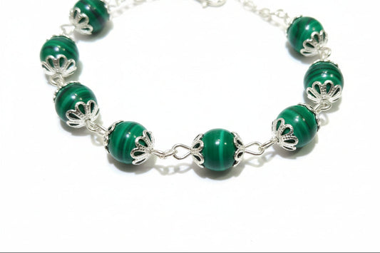 Green beaded necklace on a wooden surface