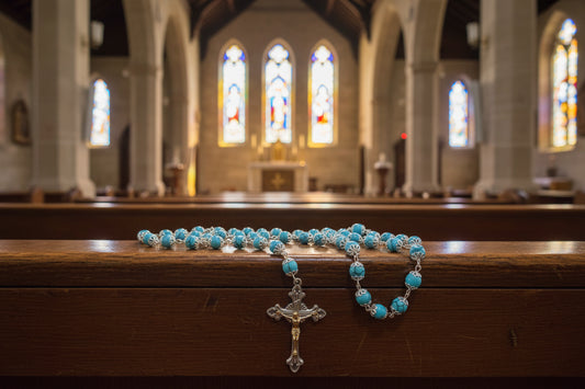 Blue rosary on a wooden surface